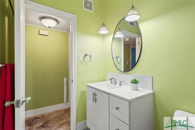 512 Winwood Pl, Savannah, GA 31419 - bathroom with vanity, decorative backsplash, baseboards, and concrete floors