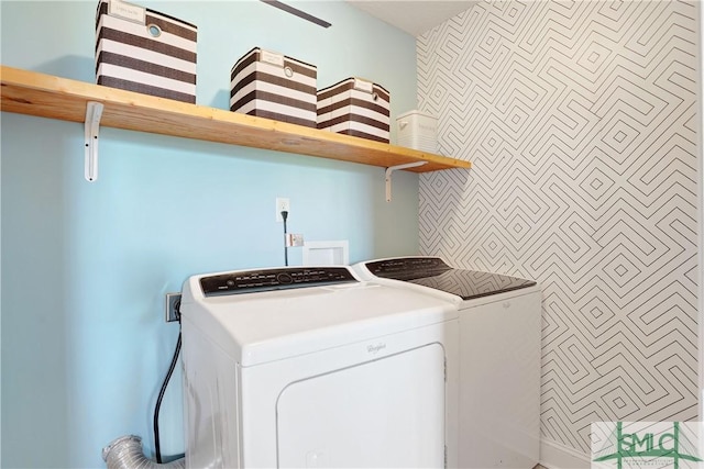 washroom featuring washing machine and clothes dryer and laundry area
