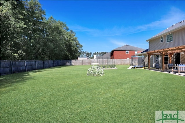 view of yard featuring a pergola, a fenced backyard, and a trampoline