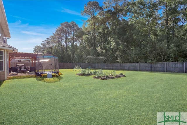 view of yard with an outbuilding, a garden, a fenced backyard, a patio area, and a shed