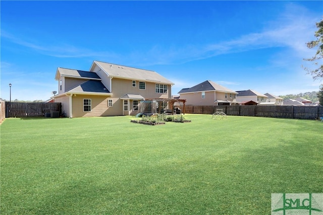 rear view of house featuring a fenced backyard, a pergola, and a yard