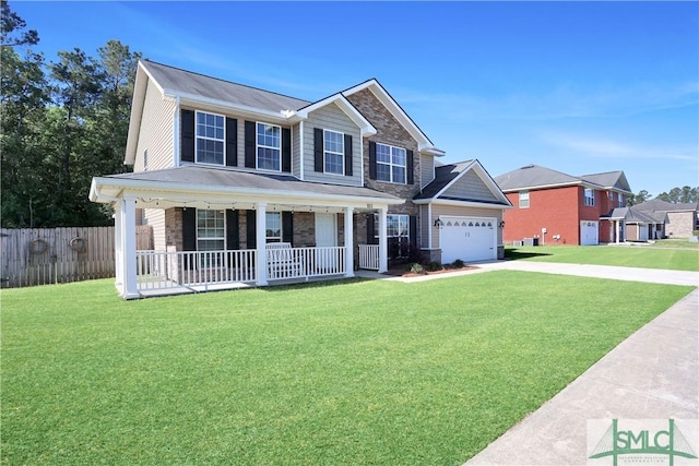 view of front of house featuring fence, a front lawn, driveway, covered porch, and a garage