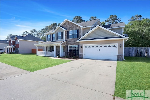 view of front of property with fence, a front lawn, driveway, stone siding, and a porch