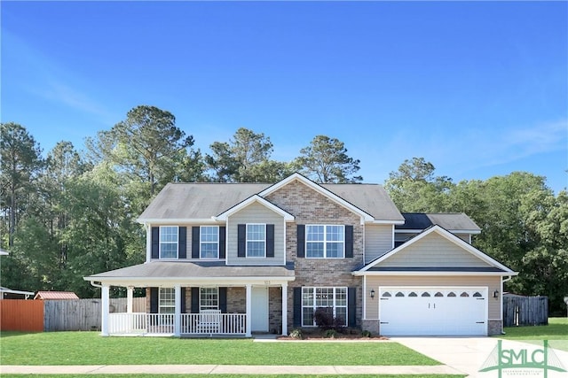 colonial home featuring an attached garage, a porch, a front lawn, and fence