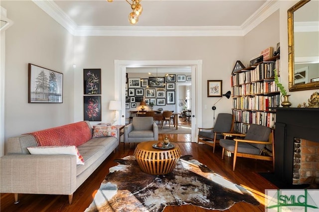 living area with wood finished floors and crown molding