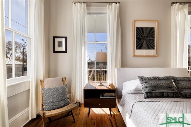 bedroom featuring hardwood / wood-style floors and multiple windows