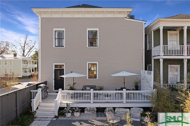 back of house with a deck