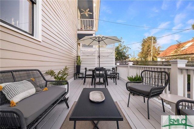 wooden deck featuring outdoor dining area