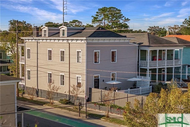 exterior space featuring roof with shingles