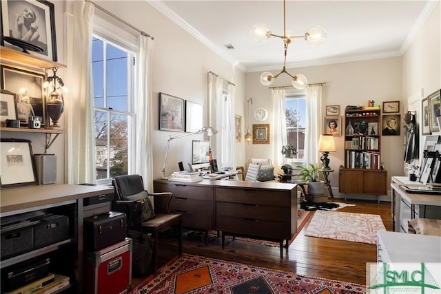living area with a notable chandelier, crown molding, and dark wood-style flooring