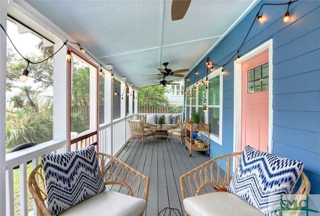 sunroom / solarium featuring ceiling fan