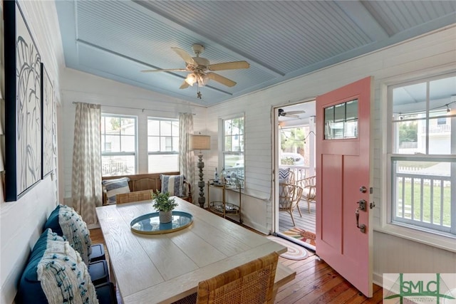 dining room featuring wood-type flooring, lofted ceiling, a wealth of natural light, and ceiling fan