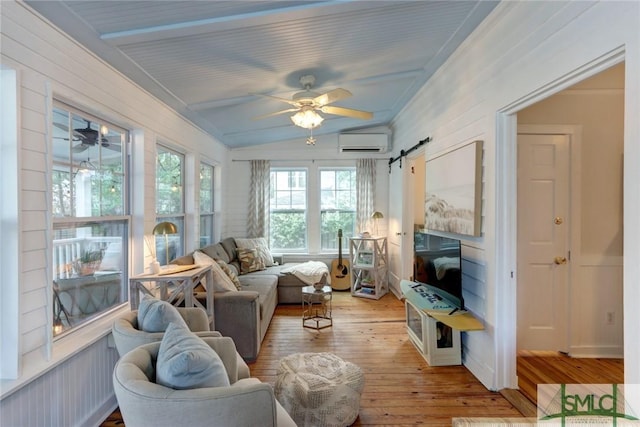sunroom / solarium with a wall mounted AC and a barn door