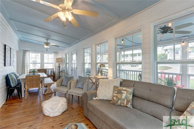sunroom featuring hardwood / wood-style flooring and beam ceiling