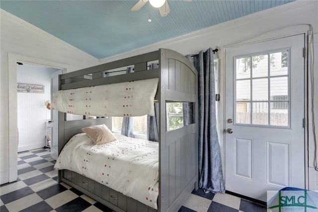 bedroom with ceiling fan, tile patterned floors, and multiple windows