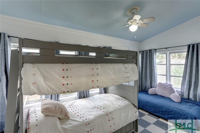 bedroom featuring lofted ceiling, tile patterned floors, and a ceiling fan