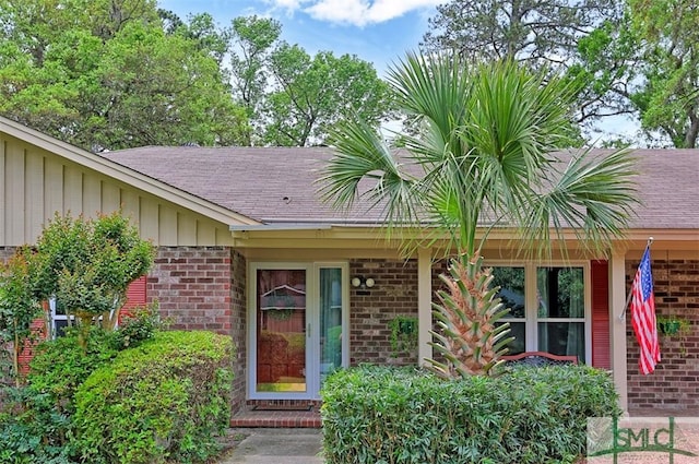 121 Steerforth Rd, Savannah, GA 31410 - property entrance featuring a shingled roof and brick siding