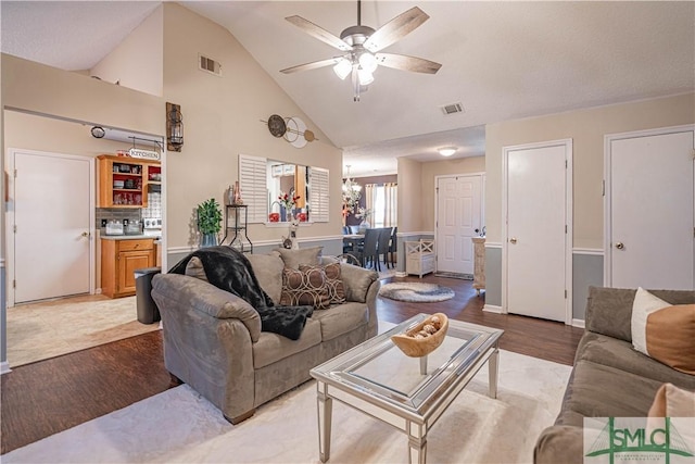living area with visible vents, a ceiling fan, and light wood-type flooring