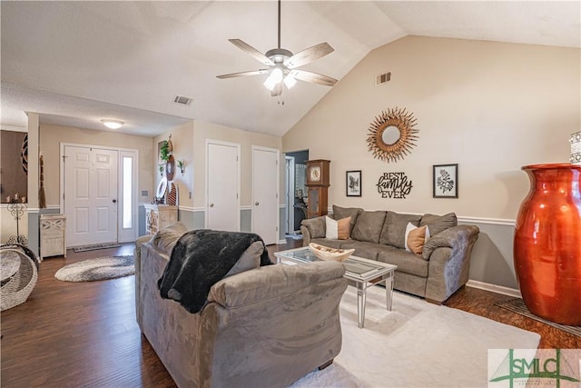 living area featuring ceiling fan, visible vents, high vaulted ceiling, and dark wood-type flooring