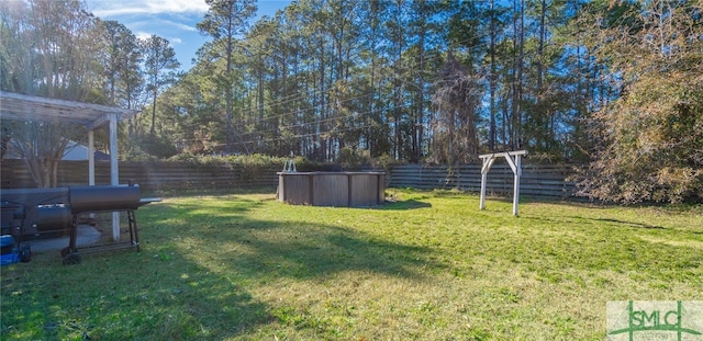 view of yard with a fenced in pool and a fenced backyard