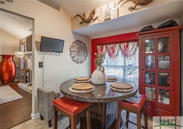 dining space with a textured ceiling and baseboards