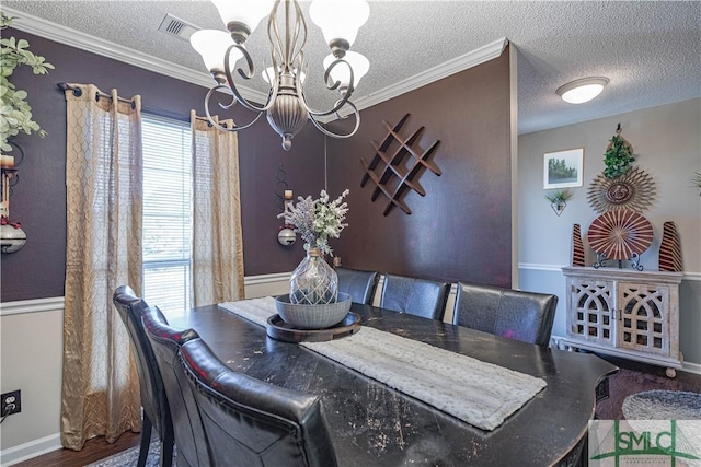 dining space with an inviting chandelier, baseboards, a textured ceiling, and visible vents