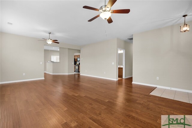 103 Regency Cir, Pooler, GA 31322 - unfurnished living room with a ceiling fan, wood finished floors, and baseboards