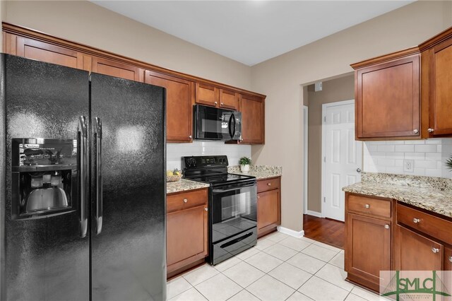 103 Regency Cir, Pooler, GA 31322 - kitchen featuring black appliances, tasteful backsplash, light tile patterned floors, and brown cabinetry