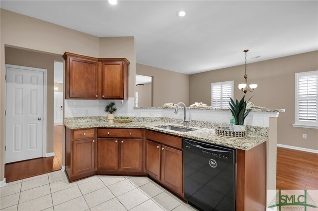103 Regency Cir, Pooler, GA 31322 - kitchen with dishwasher, a sink, a peninsula, brown cabinetry, and light stone countertops