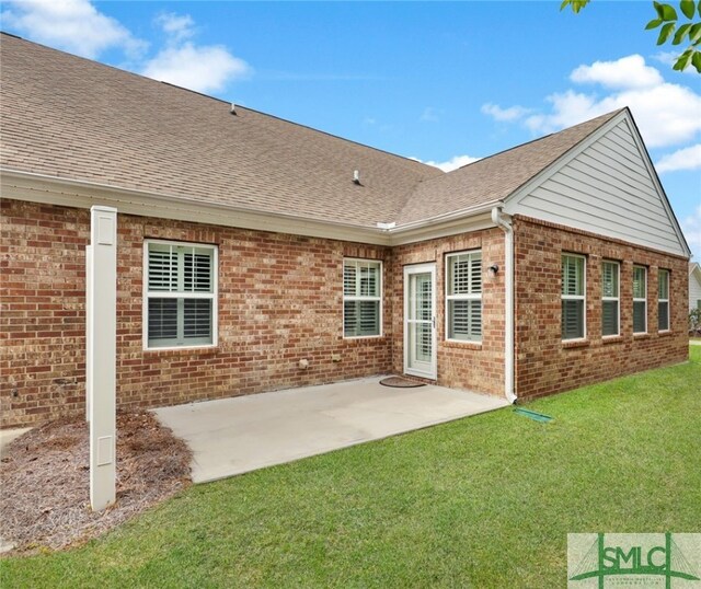 103 Regency Cir, Pooler, GA 31322 - back of property with brick siding, roof with shingles, a yard, and a patio