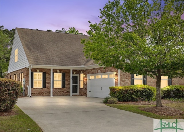 103 Regency Cir, Pooler, GA 31322 - view of front of home with brick siding, driveway, an attached garage, and roof with shingles