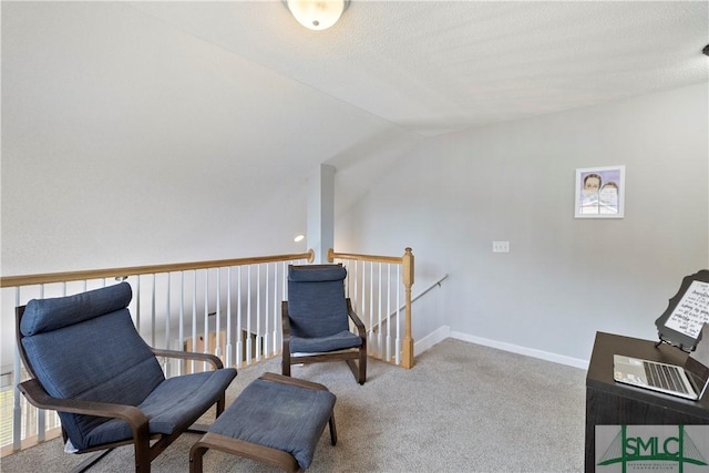 living area with an upstairs landing, carpet flooring, and vaulted ceiling