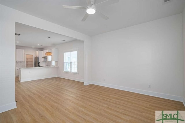 1203 E Bolton St, Savannah, GA 31404 - unfurnished living room with recessed lighting, light wood-style flooring, a ceiling fan, and baseboards