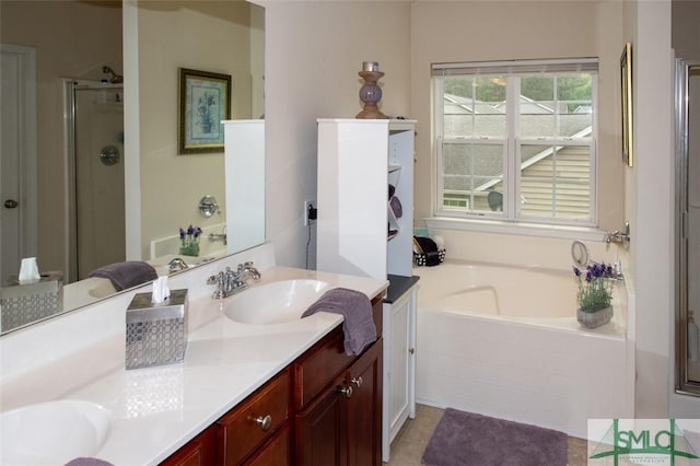 bathroom with a shower stall, tile patterned floors, double vanity, a sink, and a bath
