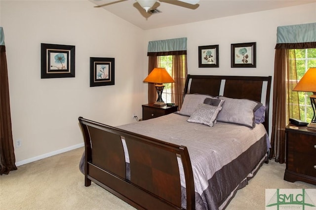 bedroom featuring lofted ceiling, a ceiling fan, baseboards, and light colored carpet