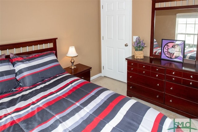 carpeted bedroom with baseboards
