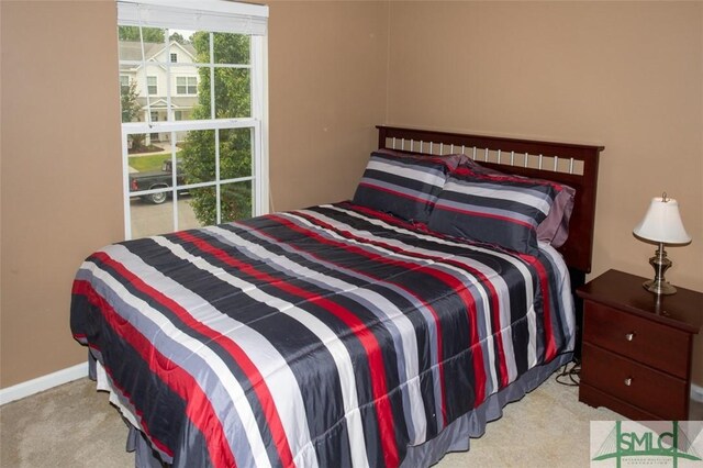 carpeted bedroom featuring baseboards