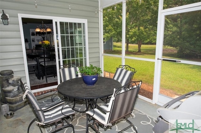sunroom with outdoor dining area and plenty of natural light