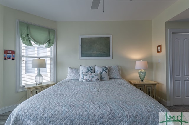 bedroom with a ceiling fan and baseboards