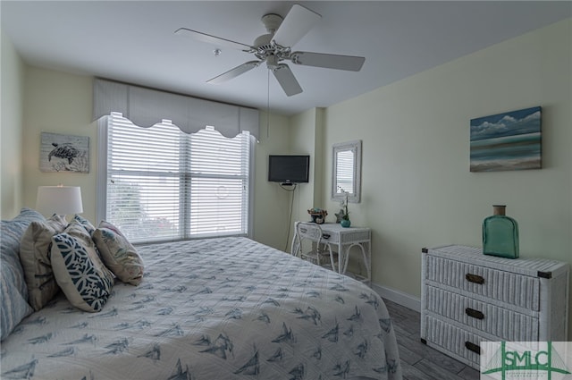 bedroom featuring wood finished floors, a ceiling fan, and baseboards