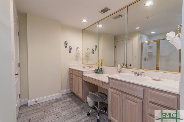 full bath with wood tiled floor, a shower stall, a sink, and visible vents