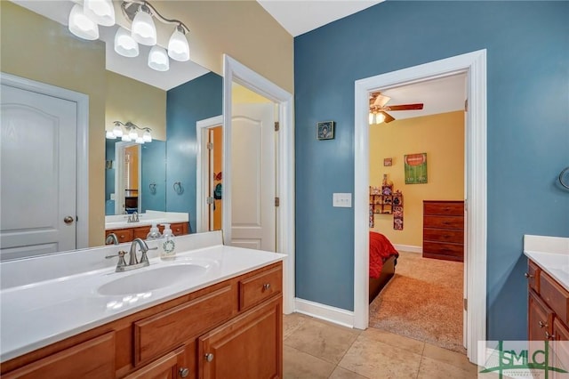 full bathroom with tile patterned flooring, a ceiling fan, a sink, baseboards, and two vanities