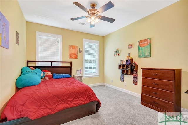 carpeted bedroom featuring visible vents, a ceiling fan, and baseboards