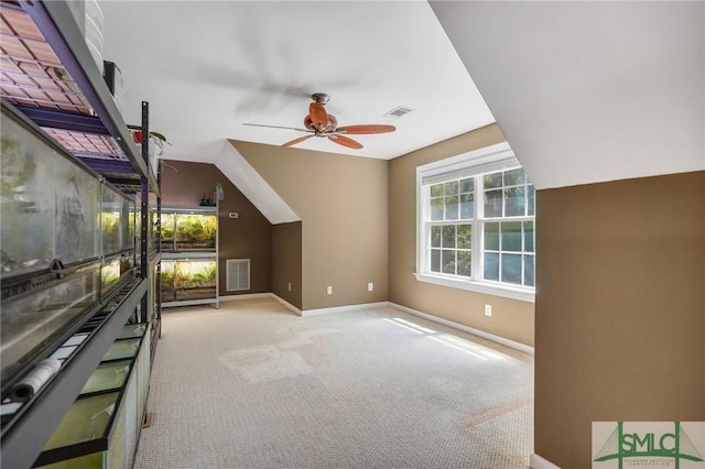 bonus room with baseboards, visible vents, carpet, and ceiling fan