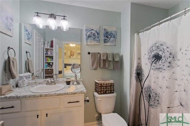 209 Bull St, Glennville, GA 30427 - bathroom featuring toilet, a shower with curtain, and vanity