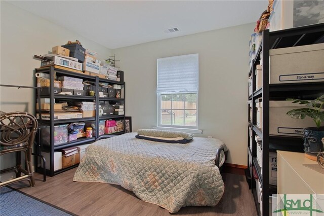 209 Bull St, Glennville, GA 30427 - bedroom with wood finished floors and visible vents