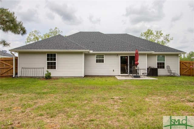 209 Bull St, Glennville, GA 30427 - back of property featuring a lawn, a patio, and fence