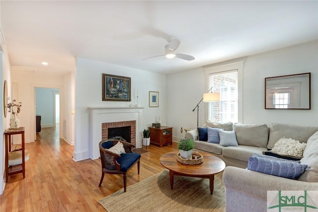 402 E 56th St, Savannah, GA 31405 - living room with baseboards, a fireplace, light wood-style floors, and ceiling fan