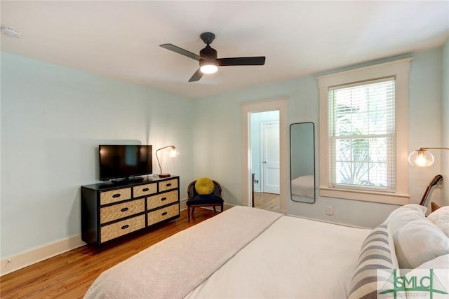 402 E 56th St, Savannah, GA 31405 - bedroom featuring baseboards, a ceiling fan, and wood finished floors