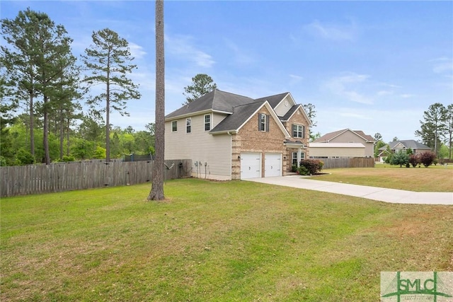 530 Briarcrest Dr NE, Ludowici, GA 31316 - view of side of property with a garage, driveway, fence, and a lawn